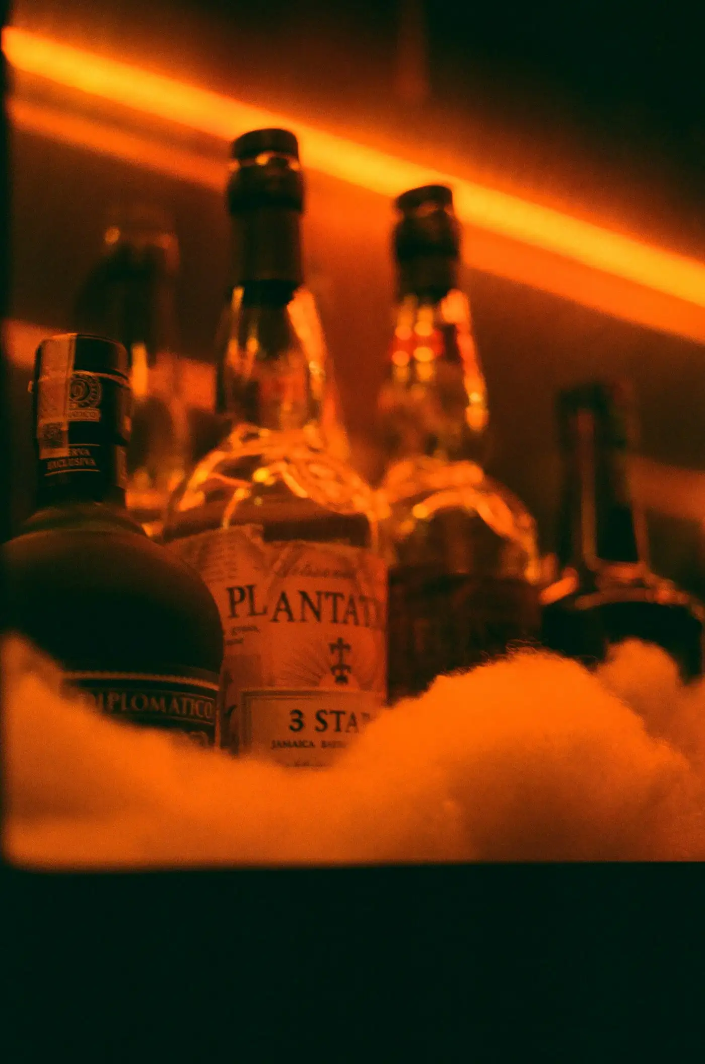 Rum bottles glowing in warm bar light