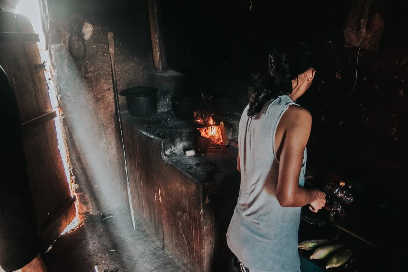 Warm light over a well-used kitchen, pots going on the stove