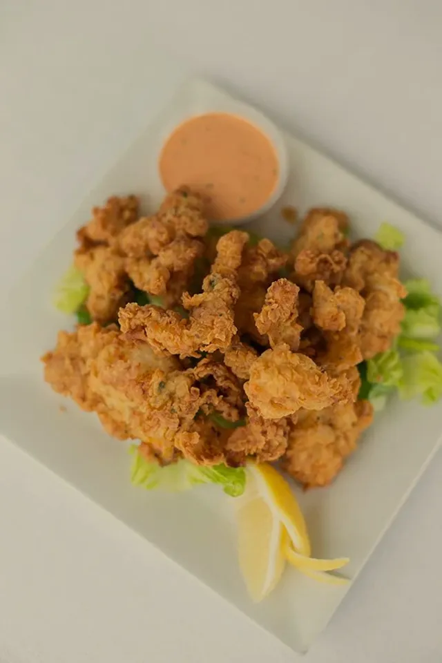 Crack conch, golden and crisp, with scotch bonnet aioli